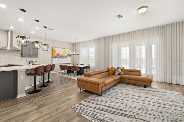 5133 Citrus Leaf Blvd, Winter Garden, FL 34787 - living room featuring light wood-type flooring, a chandelier, and recessed lighting