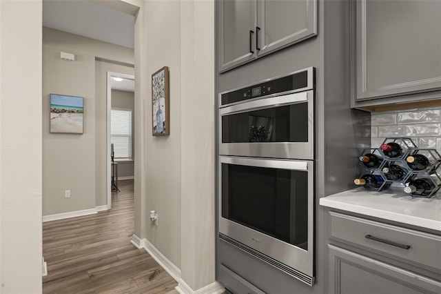 5133 Citrus Leaf Blvd, Winter Garden, FL 34787 - kitchen featuring gray cabinetry, stainless steel double oven, and wood finished floors