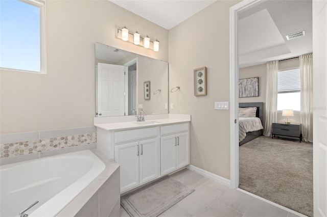 5133 Citrus Leaf Blvd, Winter Garden, FL 34787 - ensuite bathroom with vanity, a garden tub, and tile patterned floors