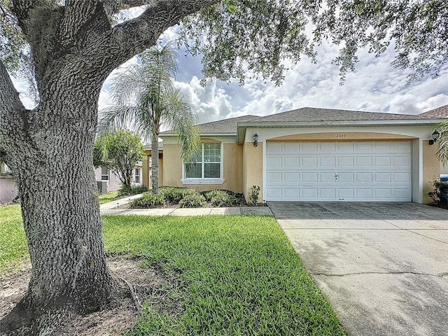 2649 Hemingway Ave, Haines City, FL 33844 - view of front of home with stucco siding, a garage, concrete driveway, and a front yard