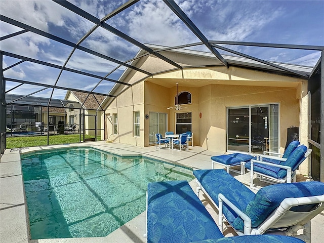 2649 Hemingway Ave, Haines City, FL 33844 - outdoor pool featuring a patio area, glass enclosure, and ceiling fan