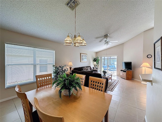 2649 Hemingway Ave, Haines City, FL 33844 - dining area featuring light tile patterned floors, a textured ceiling, lofted ceiling, a chandelier, and a ceiling fan
