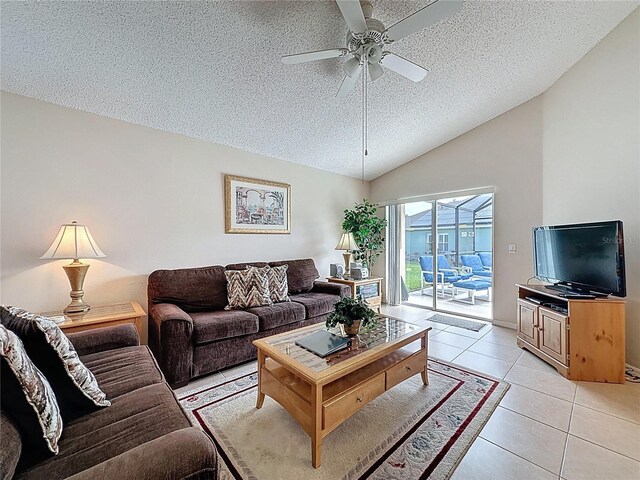 2649 Hemingway Ave, Haines City, FL 33844 - living room featuring a textured ceiling, ceiling fan, lofted ceiling, and light tile patterned floors
