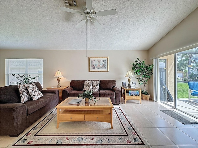 2649 Hemingway Ave, Haines City, FL 33844 - living area with a textured ceiling, ceiling fan, and light tile patterned floors