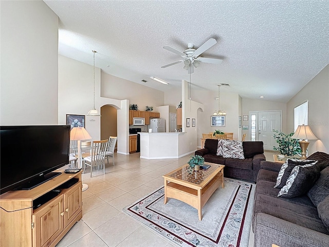 2649 Hemingway Ave, Haines City, FL 33844 - living area featuring lofted ceiling, arched walkways, a textured ceiling, ceiling fan, and light tile patterned floors