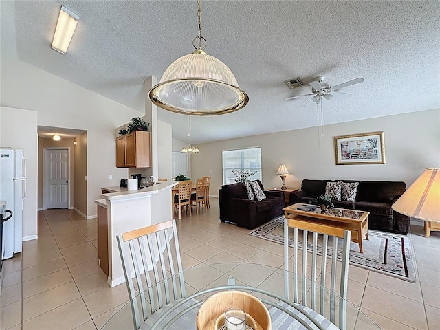 2649 Hemingway Ave, Haines City, FL 33844 - dining room featuring a ceiling fan, light tile patterned flooring, a textured ceiling, and lofted ceiling