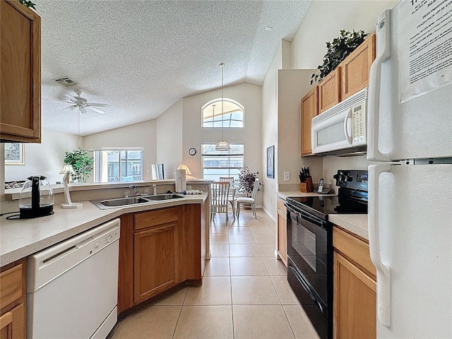 2649 Hemingway Ave, Haines City, FL 33844 - kitchen featuring white appliances, vaulted ceiling, light tile patterned floors, a textured ceiling, and a ceiling fan