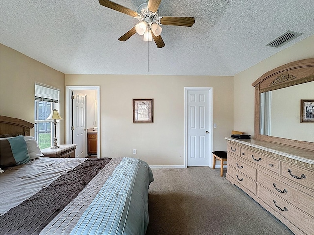 2649 Hemingway Ave, Haines City, FL 33844 - carpeted bedroom featuring a textured ceiling, ceiling fan, and ensuite bathroom