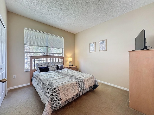 2649 Hemingway Ave, Haines City, FL 33844 - carpeted bedroom with a textured ceiling and baseboards