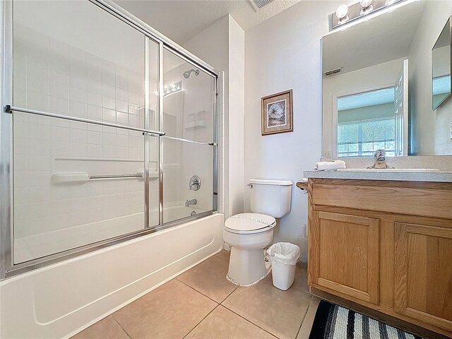 2649 Hemingway Ave, Haines City, FL 33844 - bathroom featuring tile patterned flooring, vanity, and shower / bath combination with glass door