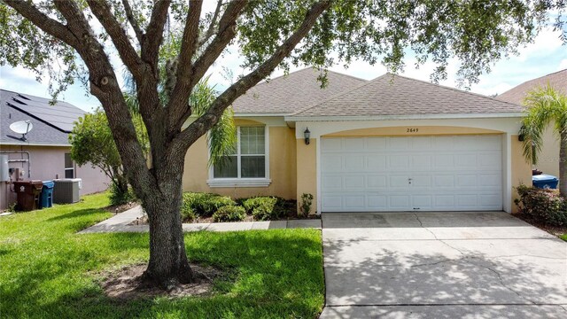 2649 Hemingway Ave, Haines City, FL 33844 - ranch-style home featuring stucco siding, driveway, roof with shingles, a front lawn, and an attached garage