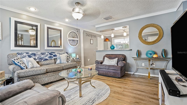 505 Oak Dr, Tavares, FL 32778 - living room with crown molding, light wood-type flooring, and a textured ceiling