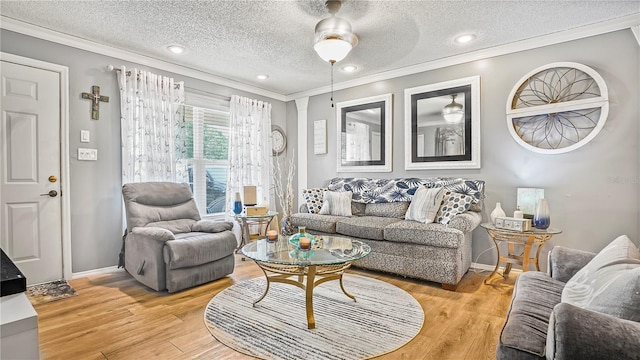 505 Oak Dr, Tavares, FL 32778 - living area featuring crown molding, light wood finished floors, a textured ceiling, and ceiling fan
