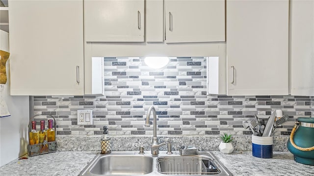 505 Oak Dr, Tavares, FL 32778 - kitchen with tasteful backsplash, white cabinetry, and light stone countertops