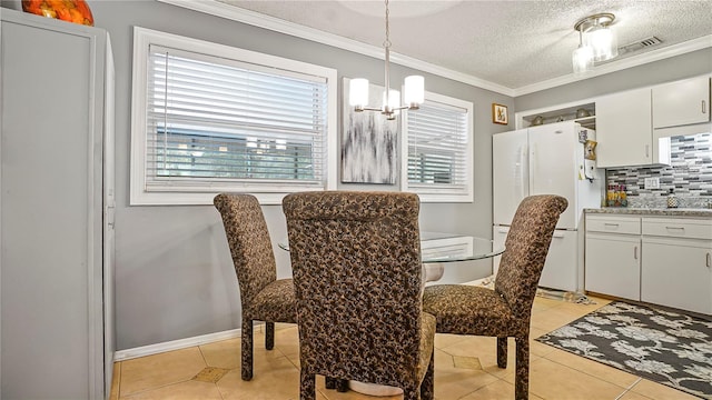 505 Oak Dr, Tavares, FL 32778 - dining area featuring light tile patterned flooring, ornamental molding, a textured ceiling, and a chandelier
