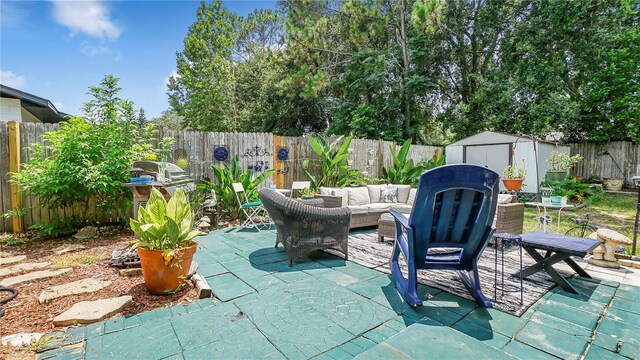 505 Oak Dr, Tavares, FL 32778 - fenced backyard featuring a patio, a shed, outdoor lounge area, and area for grilling