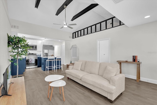 1501 Missouri Ave, Saint Cloud, FL 34769 - living room featuring arched walkways, light wood-style flooring, ceiling fan, and high vaulted ceiling