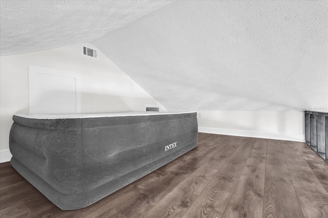 1501 Missouri Ave, Saint Cloud, FL 34769 - bathroom with a textured ceiling, lofted ceiling, and wood finished floors