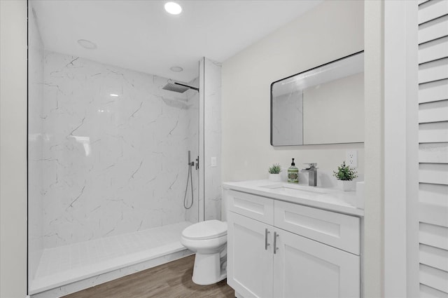 1501 Missouri Ave, Saint Cloud, FL 34769 - bathroom featuring vanity, a marble finish shower, wood finished floors, and recessed lighting