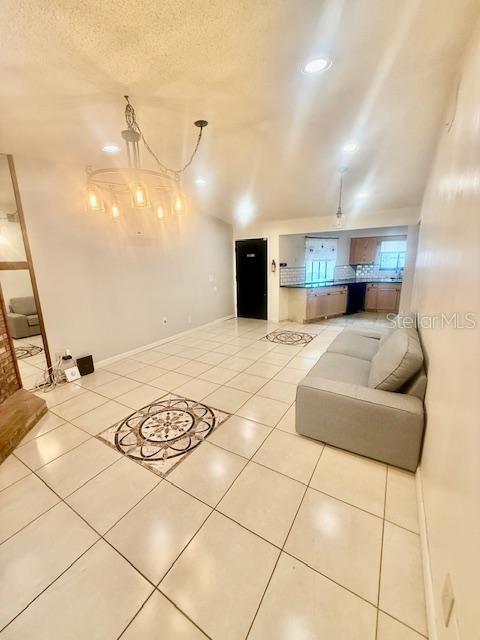 1720 Foxhall Cir Unit 1720, Kissimmee, FL 34741 - tiled living area featuring a textured ceiling and recessed lighting