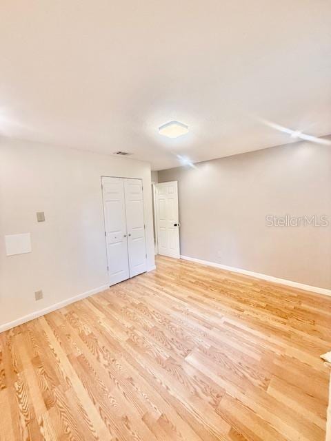 1720 Foxhall Cir Unit 1720, Kissimmee, FL 34741 - spare room with light wood-type flooring and baseboards