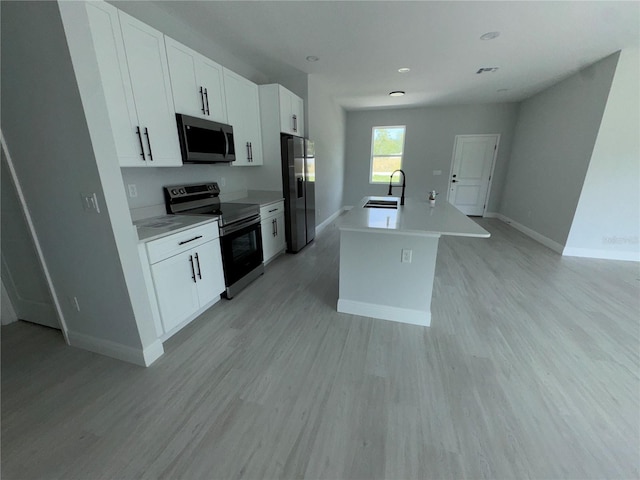 21 Pine Course Trak, Ocala, FL 34472 - kitchen with appliances with stainless steel finishes, a kitchen island with sink, white cabinets, light countertops, and recessed lighting