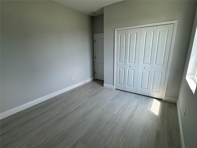 21 Pine Course Trak, Ocala, FL 34472 - unfurnished bedroom featuring wood finished floors and a closet