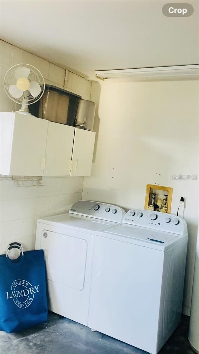 2704 Kendall Ave, Kissimmee, FL 34744 - washroom with washing machine and dryer and cabinet space