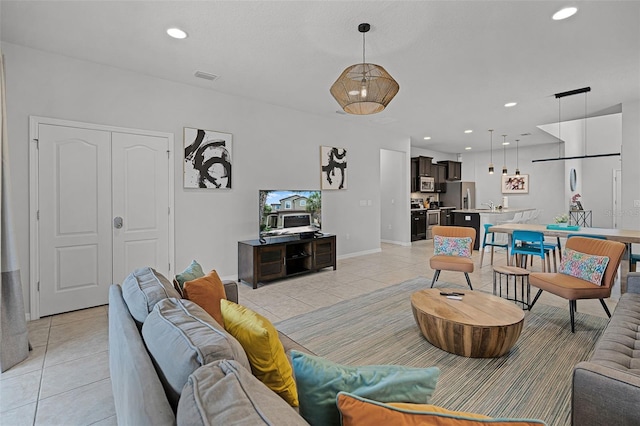 8897 Rhodes St, Kissimmee, FL 34747 - living room with light tile patterned floors and recessed lighting
