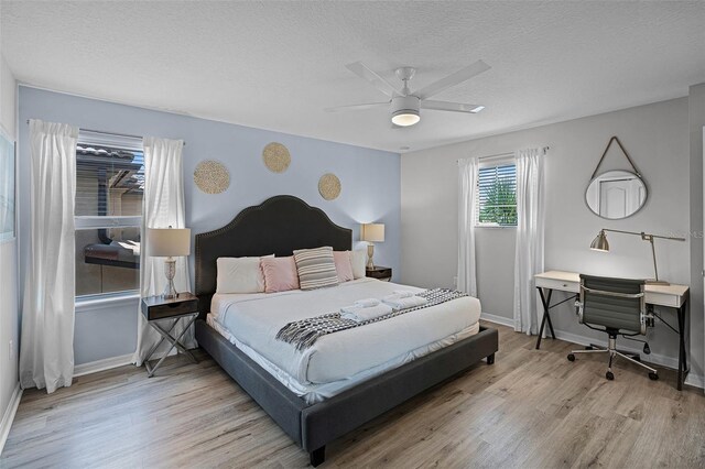 8897 Rhodes St, Kissimmee, FL 34747 - bedroom featuring wood finished floors, a textured ceiling, ceiling fan, and a desk