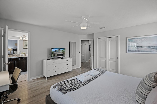 8897 Rhodes St, Kissimmee, FL 34747 - bedroom featuring light wood-style floors, a closet, ceiling fan, ensuite bath, and an office area