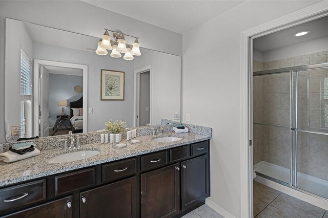 8897 Rhodes St, Kissimmee, FL 34747 - ensuite bathroom featuring tile patterned flooring, double vanity, a shower stall, and a chandelier