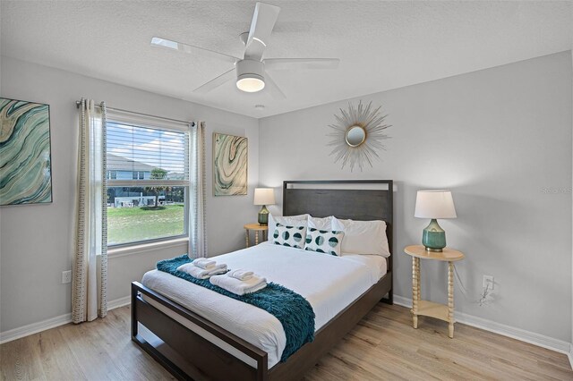 8897 Rhodes St, Kissimmee, FL 34747 - bedroom with wood finished floors, a textured ceiling, and a ceiling fan
