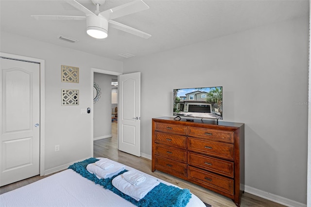 8897 Rhodes St, Kissimmee, FL 34747 - bedroom with light wood-type flooring and ceiling fan