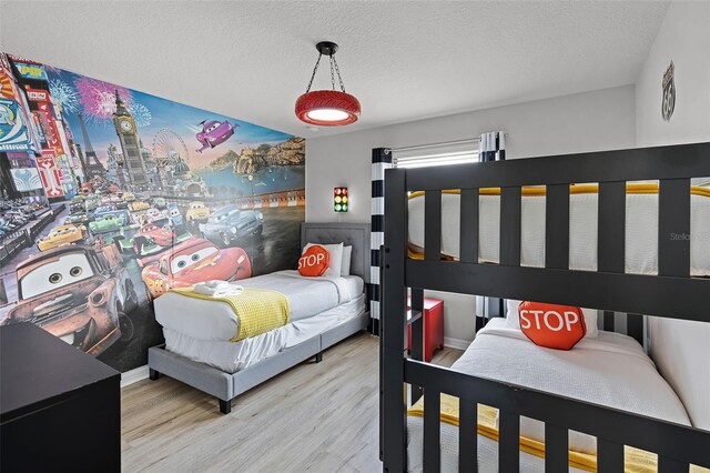 8897 Rhodes St, Kissimmee, FL 34747 - bedroom featuring wood finished floors and a textured ceiling