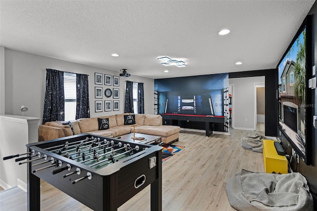 8897 Rhodes St, Kissimmee, FL 34747 - rec room with a textured ceiling, light wood-style flooring, and recessed lighting
