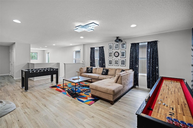 8897 Rhodes St, Kissimmee, FL 34747 - living area featuring wood finished floors, recessed lighting, and a textured ceiling