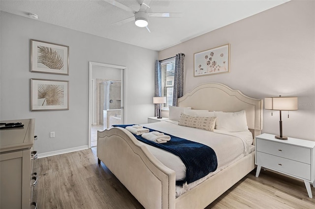 8897 Rhodes St, Kissimmee, FL 34747 - bedroom featuring wood finished floors, ensuite bath, and ceiling fan
