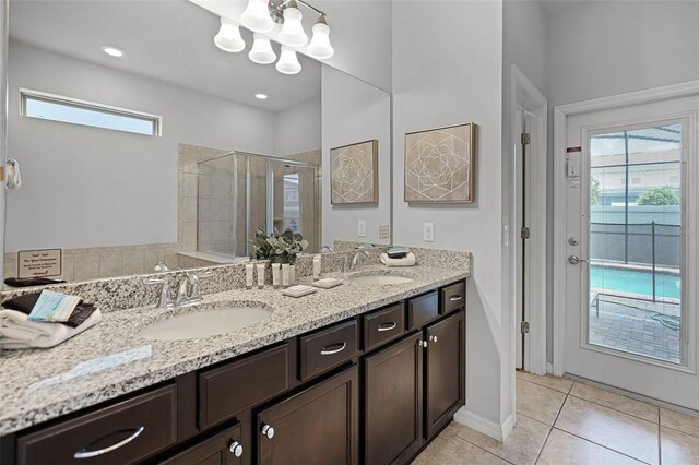 8897 Rhodes St, Kissimmee, FL 34747 - full bath featuring double vanity, a shower stall, plenty of natural light, and tile patterned flooring