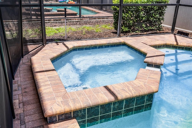 8897 Rhodes St, Kissimmee, FL 34747 - swimming pool featuring an in-ground hot tub and a lanai