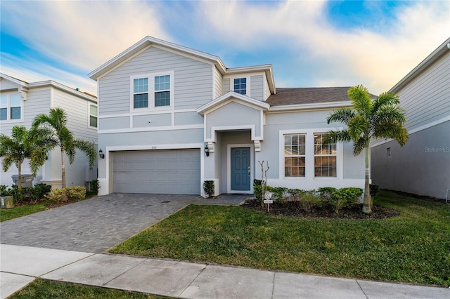 2161 Lelani Cir, Davenport, FL 33897 - view of front of house featuring decorative driveway, stucco siding, a garage, and a front lawn