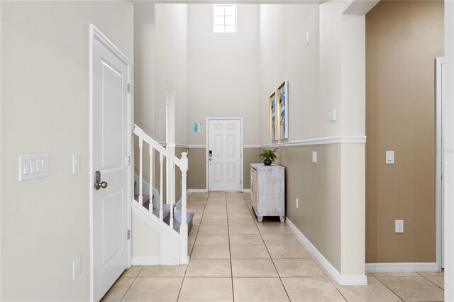 2161 Lelani Cir, Davenport, FL 33897 - foyer featuring light tile patterned flooring, stairway, and a high ceiling