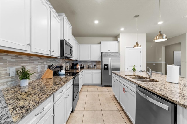 2161 Lelani Cir, Davenport, FL 33897 - kitchen with stainless steel appliances, tasteful backsplash, white cabinets, and recessed lighting
