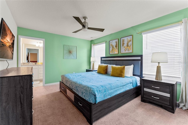 2161 Lelani Cir, Davenport, FL 33897 - bedroom with light colored carpet, a ceiling fan, and connected bathroom