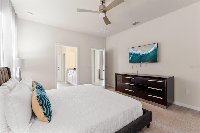 2161 Lelani Cir, Davenport, FL 33897 - bedroom featuring ensuite bathroom, a ceiling fan, and light carpet