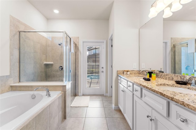 2161 Lelani Cir, Davenport, FL 33897 - bathroom featuring a shower stall, double vanity, a bath, and tile patterned floors