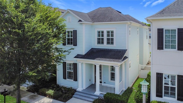 1513 Resolute St, Celebration, FL 34747 - view of front of property featuring covered porch and a shingled roof