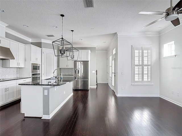 1513 Resolute St, Celebration, FL 34747 - kitchen featuring stainless steel appliances, dark countertops, a ceiling fan, a chandelier, and dark wood-style floors