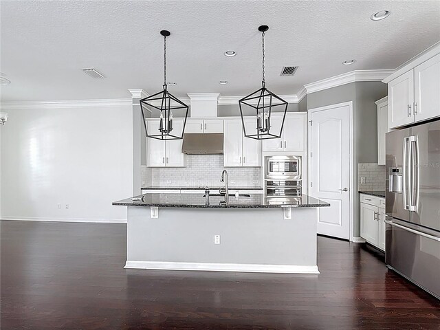 1513 Resolute St, Celebration, FL 34747 - kitchen featuring appliances with stainless steel finishes, under cabinet range hood, a chandelier, crown molding, and an island with sink