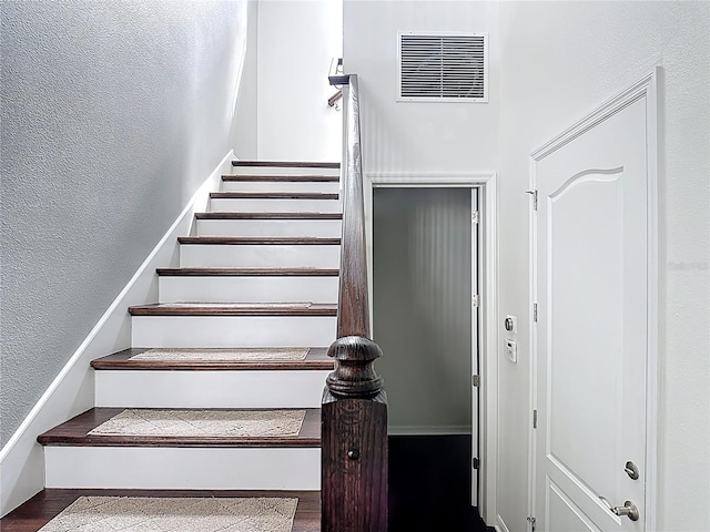 1513 Resolute St, Celebration, FL 34747 - staircase featuring wood finished floors and a textured wall